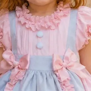 Detalle del cuerpo del vestido de niña Leonor con lorzas, botones y bandas
